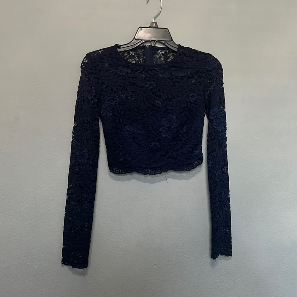 The top is lace, both the top and bottom have a zipper in the back